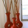 1 set of three red vases